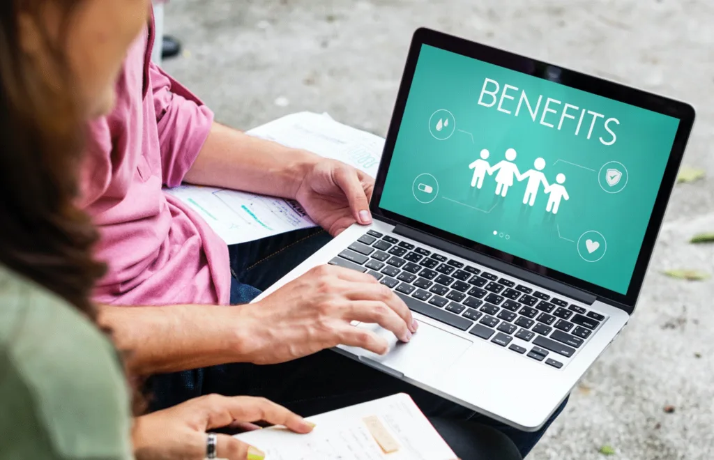 Reviewing employee benefits packages on a laptop computer.