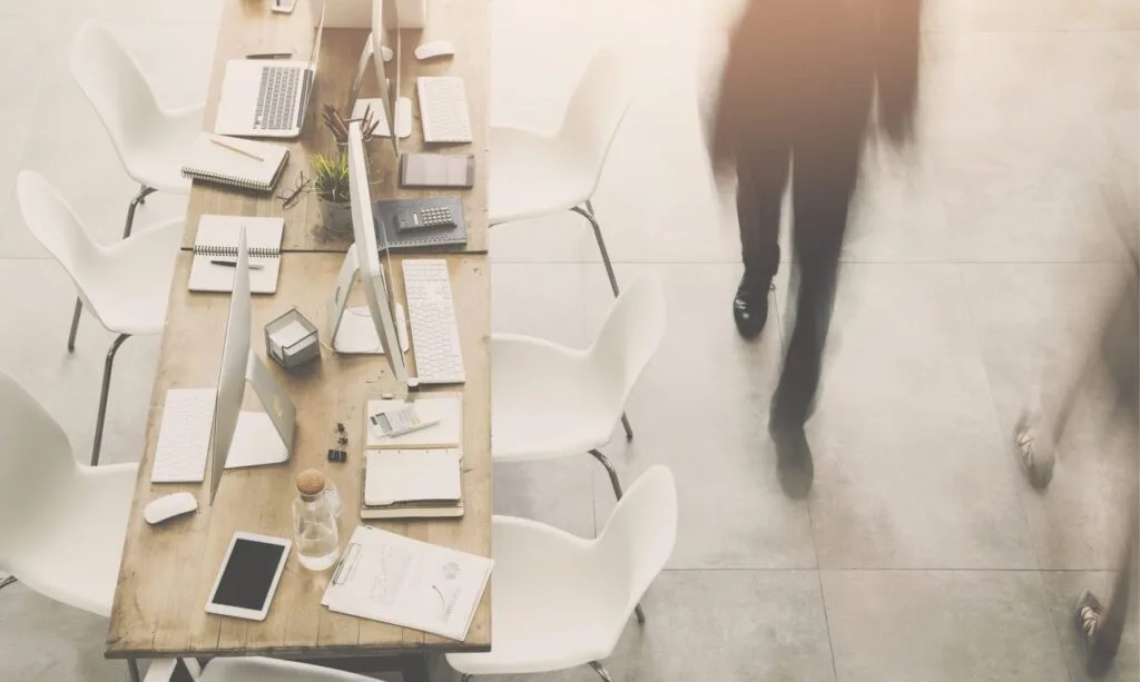 Business man passing by table