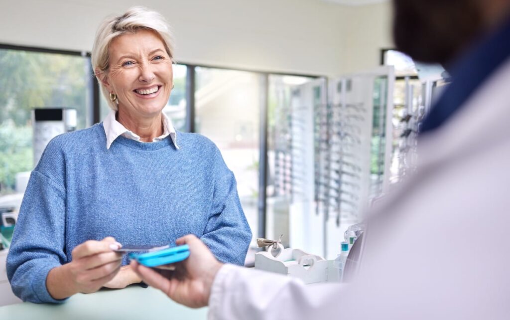 Happy customer pays for healthcare services.